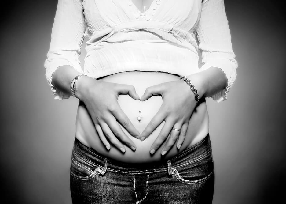 Maternity bump with hands in a heart shape